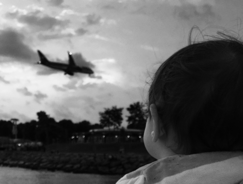 Baby watching plane